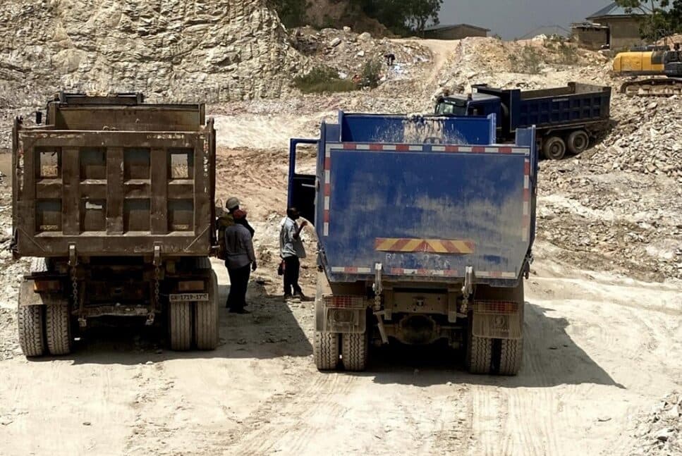 Tipper trucks at a quarry and logistics staging area